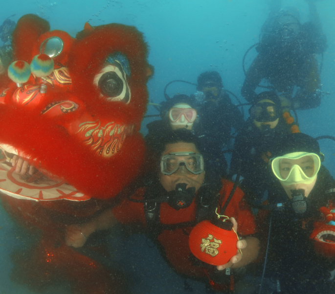 Poni Divers performs underwater lion dance at open sea